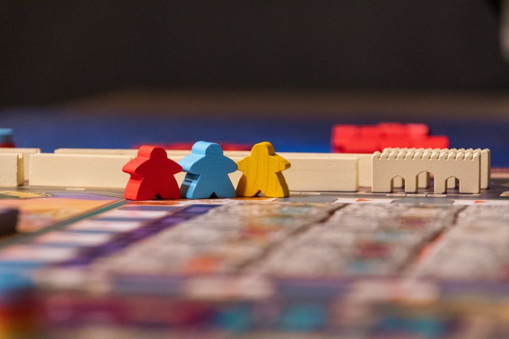 Meeple figures on board. game table